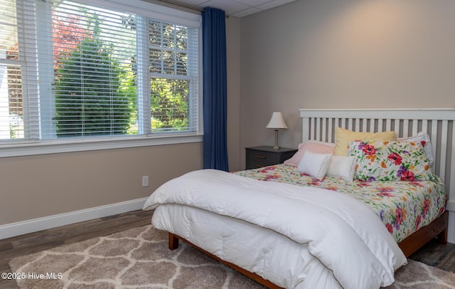 118 Dennis Cir W, End, NC 27376 - bedroom with wood finished floors, multiple windows, and baseboards