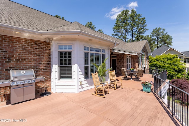 view of patio / terrace with an outdoor kitchen, outdoor dining area, grilling area, and a deck