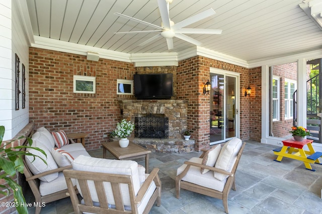 view of patio featuring a ceiling fan and an outdoor living space with a fireplace
