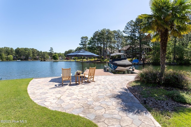 view of dock featuring a water view and a yard