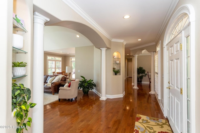 hall with recessed lighting, arched walkways, and ornate columns