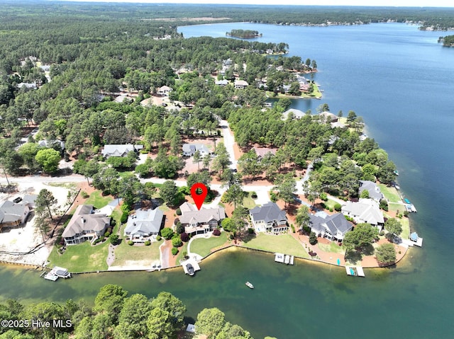 aerial view with a water view, a view of trees, and a residential view