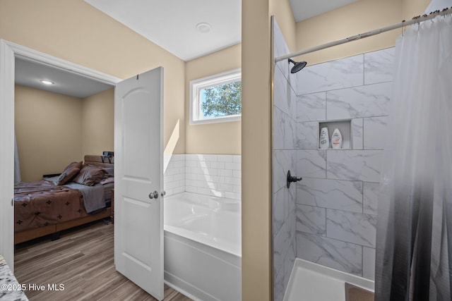 1203 English Colony Pl, Washington, NC 27889 - ensuite bathroom featuring a garden tub, wood finished floors, and tiled shower