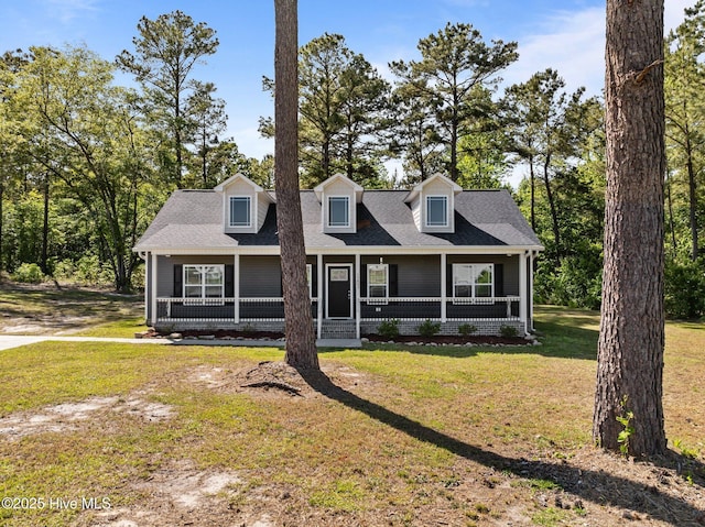 1203 English Colony Pl, Washington, NC 27889 - new england style home featuring a front lawn, covered porch, and roof with shingles
