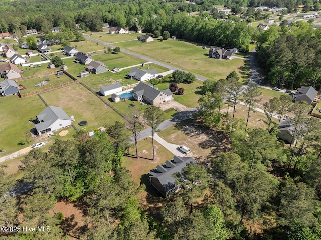 aerial view featuring a wooded view
