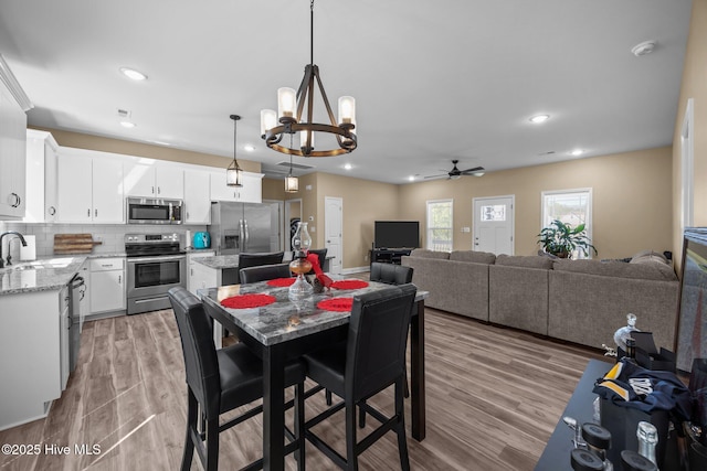 1203 English Colony Pl, Washington, NC 27889 - dining room featuring a ceiling fan, a chandelier, light wood finished floors, and recessed lighting