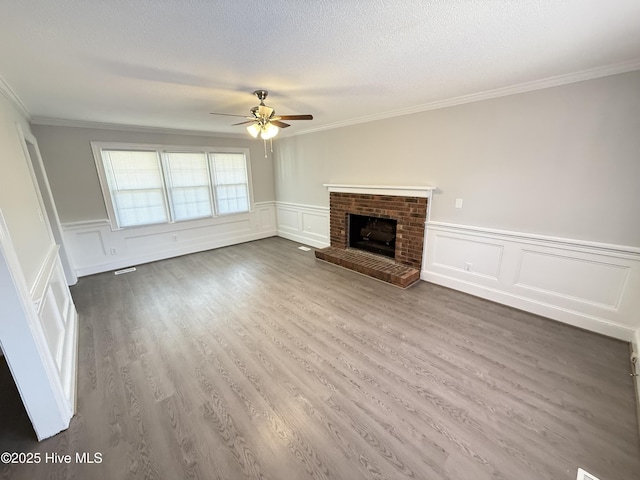 120 Ridgecrest Dr, Mount Olive, NC 28365 - unfurnished living room with wainscoting, ceiling fan, ornamental molding, and wood finished floors