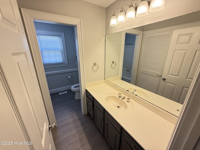 120 Ridgecrest Dr, Mount Olive, NC 28365 - bathroom featuring toilet, baseboards, wood finished floors, and vanity