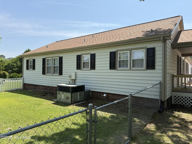 120 Ridgecrest Dr, Mount Olive, NC 28365 - back of property with crawl space, a lawn, cooling unit, a fenced backyard, and a shingled roof