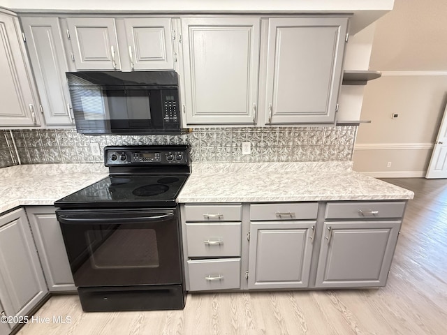 120 Ridgecrest Dr, Mount Olive, NC 28365 - kitchen featuring gray cabinetry, light countertops, tasteful backsplash, and black appliances