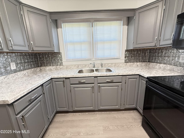 120 Ridgecrest Dr, Mount Olive, NC 28365 - kitchen with electric range, light wood-style floors, light countertops, a sink, and gray cabinetry