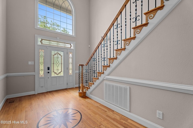 106 Cliffwell Dr, Goldsboro, NC 27530 - foyer entrance with wood finished floors, baseboards, stairway, and a towering ceiling