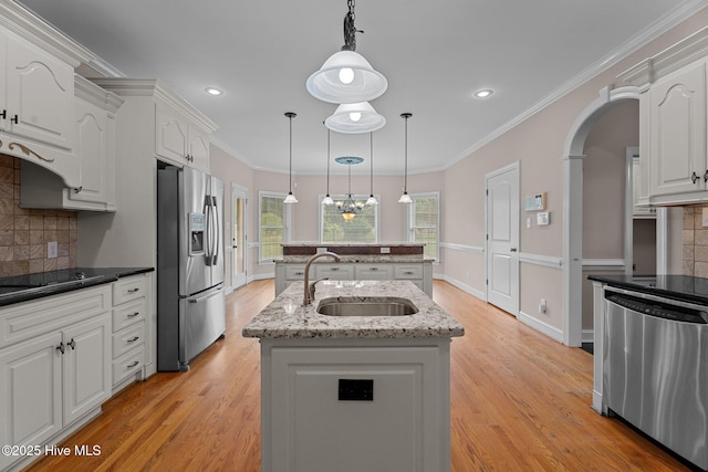 106 Cliffwell Dr, Goldsboro, NC 27530 - kitchen with appliances with stainless steel finishes, a sink, a center island, tasteful backsplash, and decorative light fixtures
