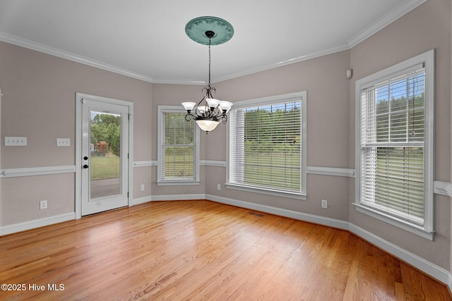106 Cliffwell Dr, Goldsboro, NC 27530 - unfurnished dining area with a chandelier, wood finished floors, baseboards, and ornamental molding