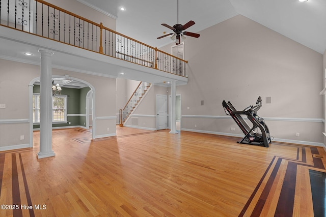 106 Cliffwell Dr, Goldsboro, NC 27530 - unfurnished living room featuring arched walkways, decorative columns, wood finished floors, a ceiling fan, and stairway