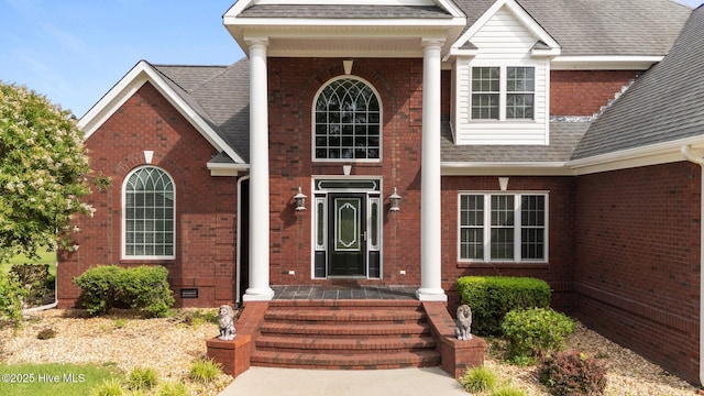 106 Cliffwell Dr, Goldsboro, NC 27530 - property entrance with a porch, brick siding, and roof with shingles