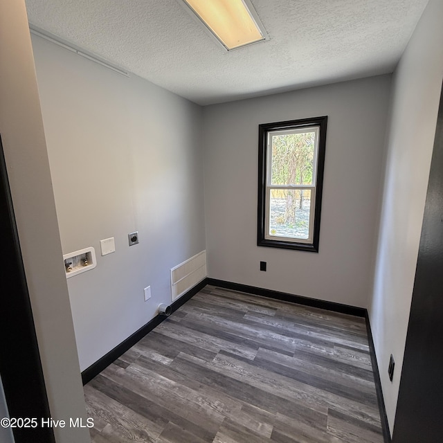 laundry room with washer hookup, hookup for an electric dryer, laundry area, dark wood-style flooring, and a textured ceiling