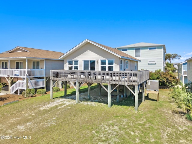 421 35th St, Sunset Beach, NC 28468 - back of property with stairs, a yard, a wooden deck, dirt driveway, and central AC unit
