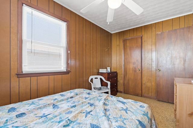 421 35th St, Sunset Beach, NC 28468 - bedroom featuring multiple windows, wooden walls, a ceiling fan, and carpet floors