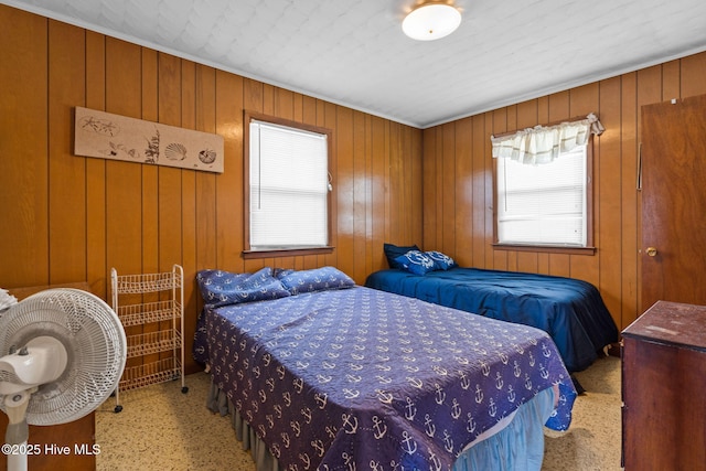 421 35th St, Sunset Beach, NC 28468 - bedroom featuring wood walls, speckled floor, and crown molding