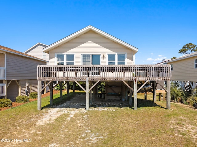 421 35th St, Sunset Beach, NC 28468 - back of house featuring a carport, dirt driveway, a deck, and a yard