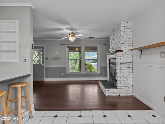 unfurnished living room with crown molding, plenty of natural light, and a ceiling fan