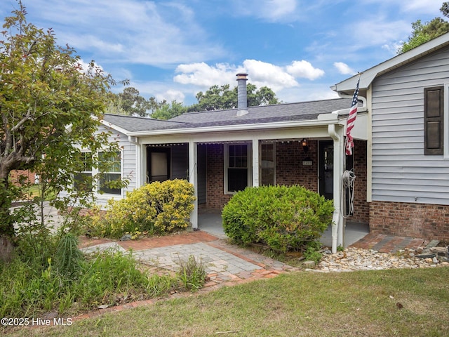 40 Eagle Rock Ln, Hubert, NC 28539 - back of property with roof with shingles, a lawn, and brick siding