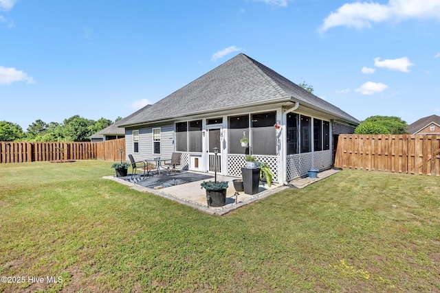 rear view of property with a sunroom, a patio area, and roof with shingles