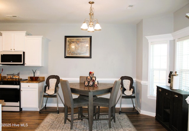 dining space with an inviting chandelier, baseboards, dark wood-type flooring, and visible vents