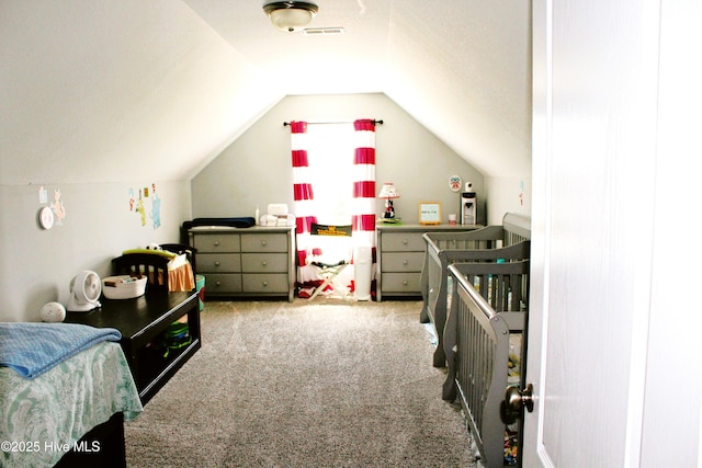 bedroom with vaulted ceiling, carpet flooring, and visible vents