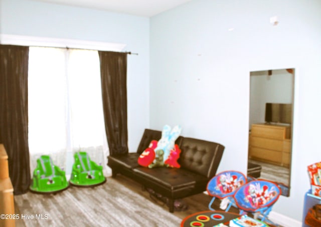 game room with plenty of natural light and wood finished floors
