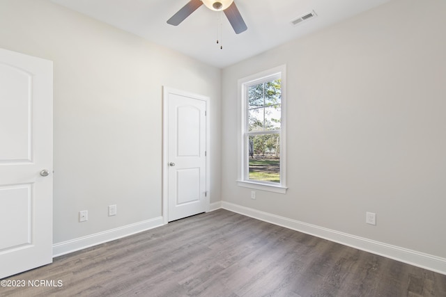 unfurnished bedroom featuring wood finished floors, baseboards, and ceiling fan