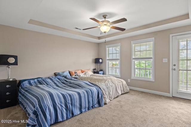 248 Seville St, Jacksonville, NC 28546 - carpeted bedroom featuring a tray ceiling, baseboards, access to exterior, and a ceiling fan