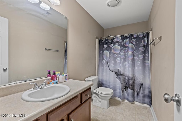 248 Seville St, Jacksonville, NC 28546 - bathroom featuring toilet, vanity, tile patterned floors, and a shower with shower curtain