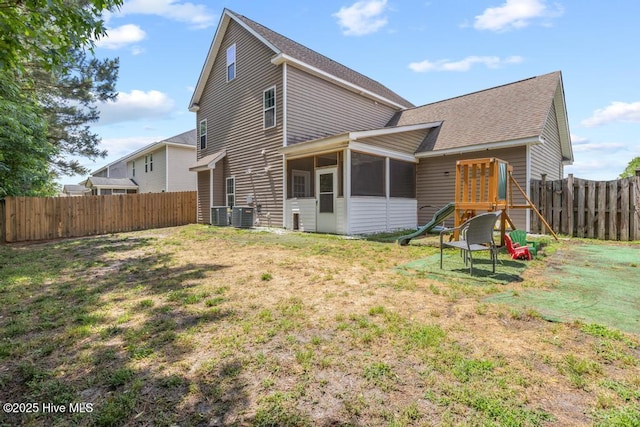 248 Seville St, Jacksonville, NC 28546 - rear view of property featuring a sunroom, a shingled roof, and central air condition unit