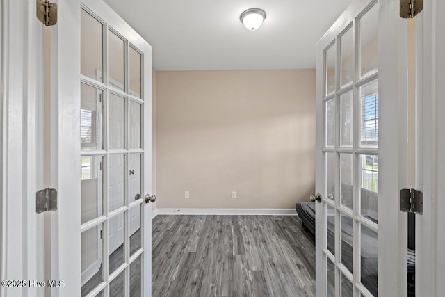 248 Seville St, Jacksonville, NC 28546 - unfurnished room featuring baseboards, wood finished floors, and french doors