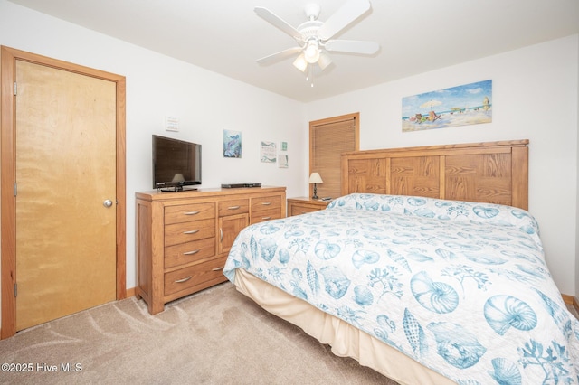 bedroom with a ceiling fan and light colored carpet