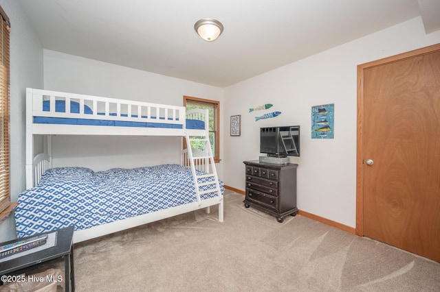 bedroom featuring baseboards and carpet flooring