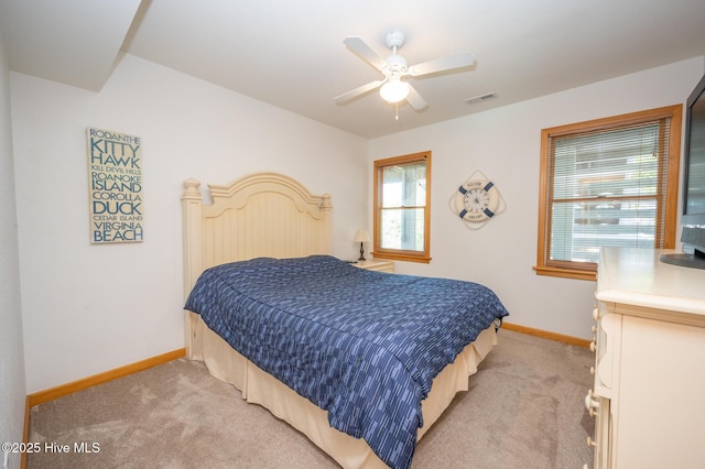 bedroom with light colored carpet, baseboards, ceiling fan, and visible vents