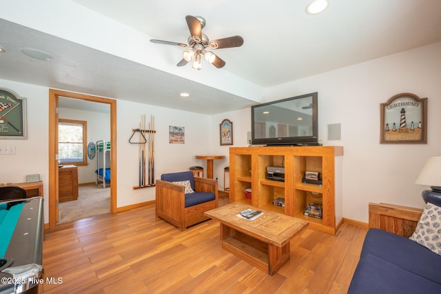living room with a ceiling fan, baseboards, recessed lighting, and light wood-style floors