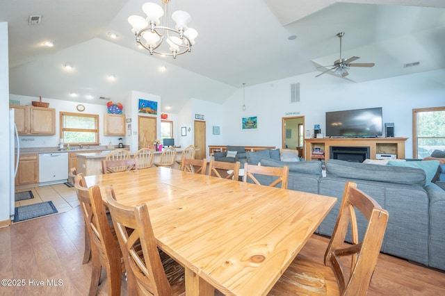 dining space with ceiling fan with notable chandelier, recessed lighting, light wood-style flooring, and visible vents