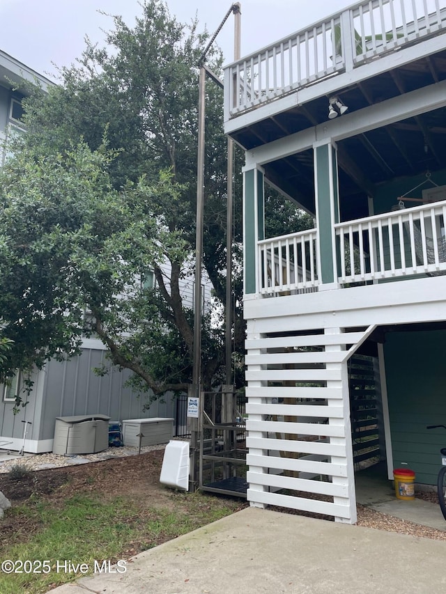 view of property exterior featuring fence and a balcony