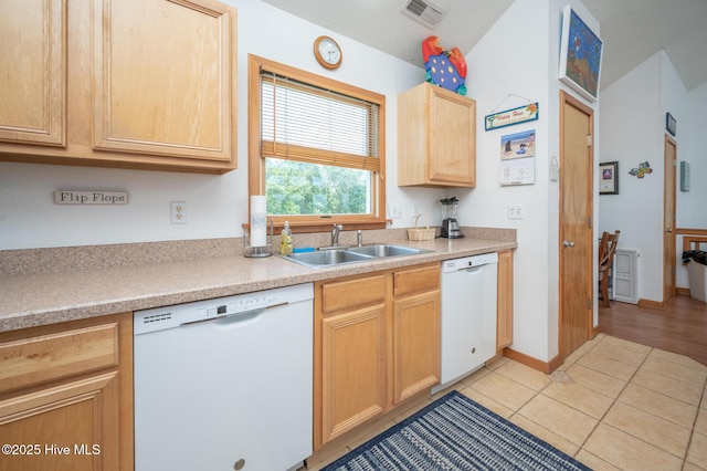 kitchen with a sink, light brown cabinetry, visible vents, and dishwasher