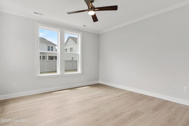empty room featuring baseboards, ornamental molding, light wood-type flooring, and ceiling fan
