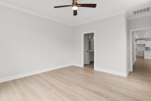 unfurnished bedroom featuring baseboards, visible vents, ornamental molding, and light wood-style flooring