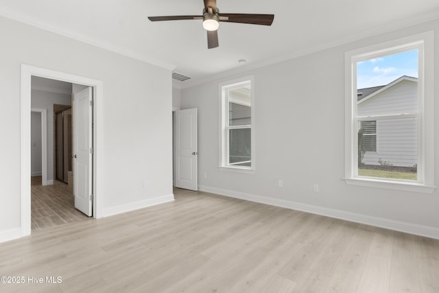 unfurnished bedroom with baseboards, visible vents, ornamental molding, and light wood finished floors