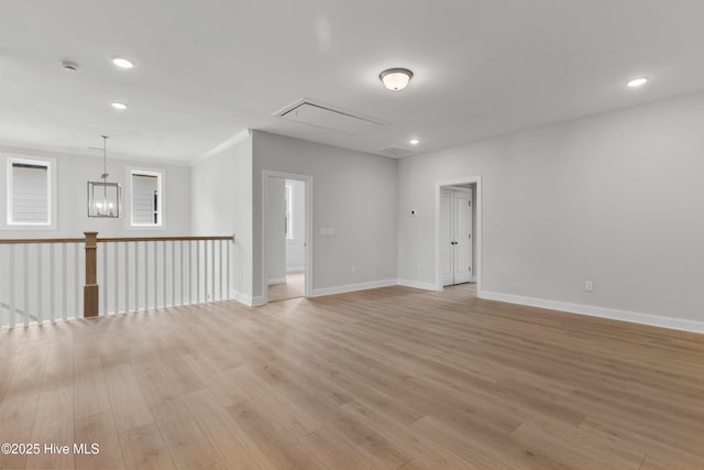 empty room featuring crown molding, recessed lighting, baseboards, and light wood-style floors