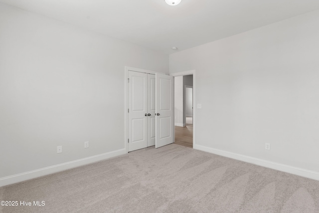 empty room with carpet floors and baseboards