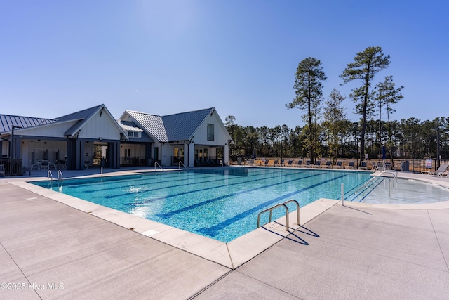pool featuring fence and a patio area