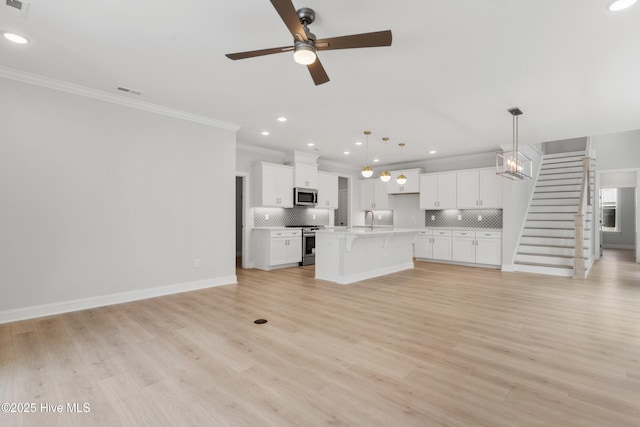 unfurnished living room featuring crown molding, a sink, stairway, recessed lighting, and a ceiling fan